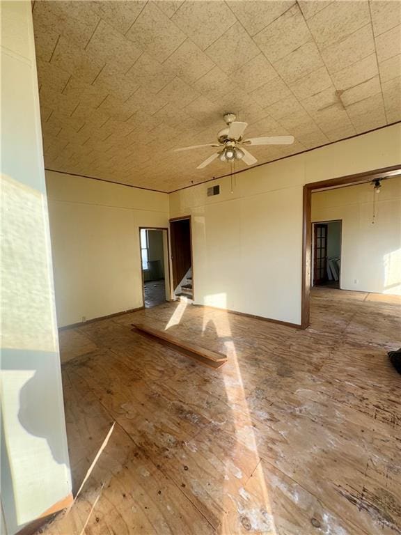 empty room with ceiling fan and hardwood / wood-style floors