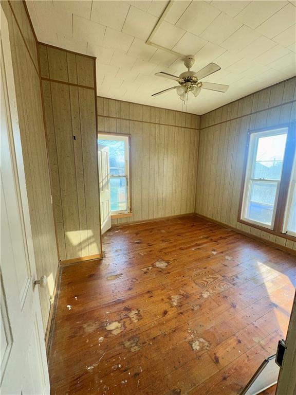 unfurnished room with ceiling fan, plenty of natural light, and light hardwood / wood-style flooring