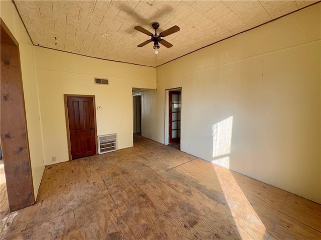 spare room featuring ceiling fan and heating unit