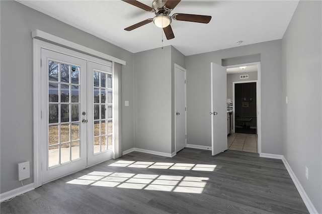 interior space featuring access to exterior, french doors, baseboards, and wood finished floors