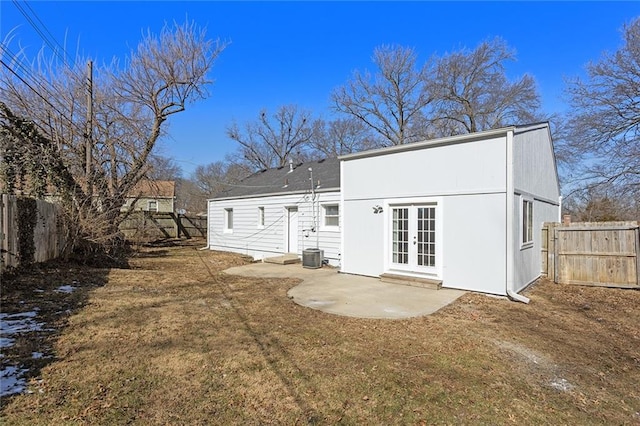 back of property with french doors, a fenced backyard, a patio, and central air condition unit