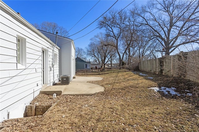 view of yard featuring a patio area, fence, and central air condition unit