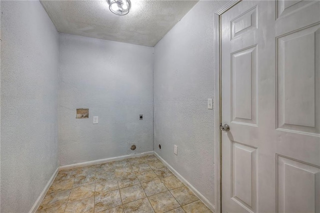 laundry area featuring a textured ceiling, a textured wall, hookup for an electric dryer, laundry area, and baseboards