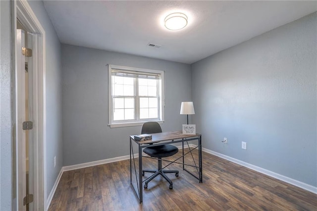 office featuring wood finished floors, visible vents, and baseboards