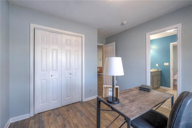 home office featuring baseboards and wood finished floors