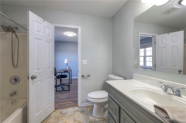 full bathroom with baseboards, visible vents, toilet, vanity, and shower / washtub combination