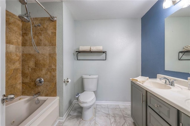 full bathroom featuring toilet, vanity, baseboards, marble finish floor, and washtub / shower combination