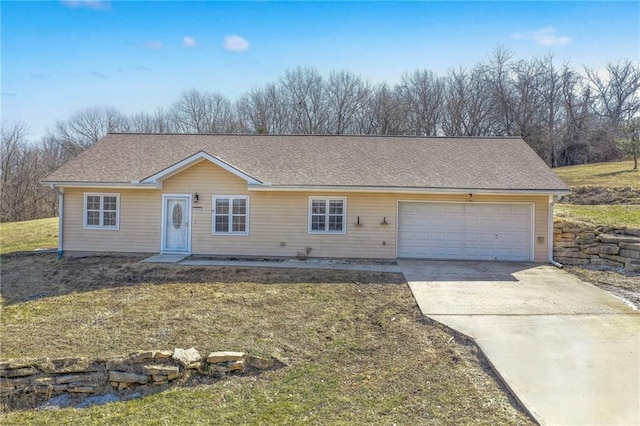 ranch-style house with a garage, concrete driveway, a front lawn, and a shingled roof