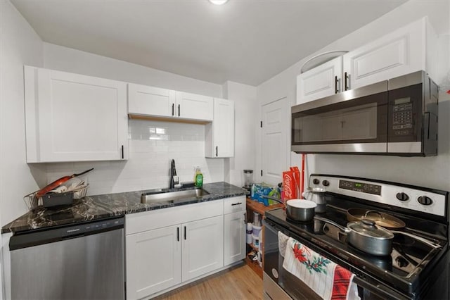 kitchen with white cabinets, stainless steel appliances, and a sink