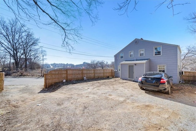 back of house with fence