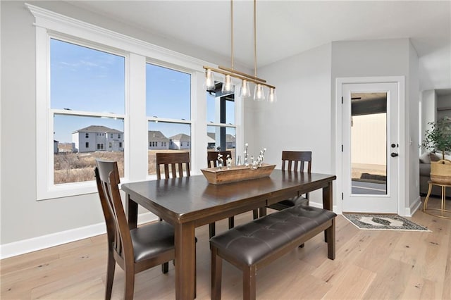 dining area with light wood-type flooring and a wealth of natural light