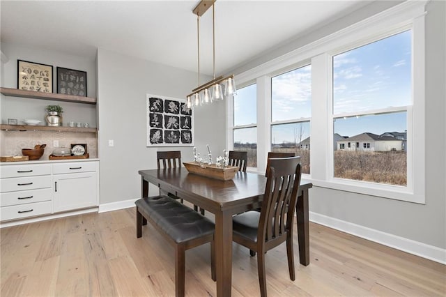 dining area with light wood-type flooring and a wealth of natural light