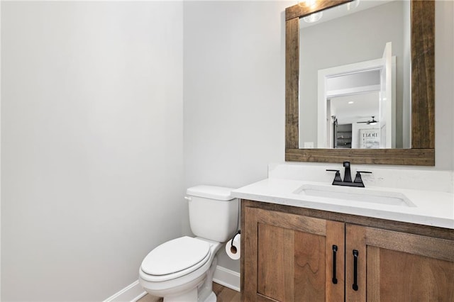 bathroom with ceiling fan, toilet, and vanity