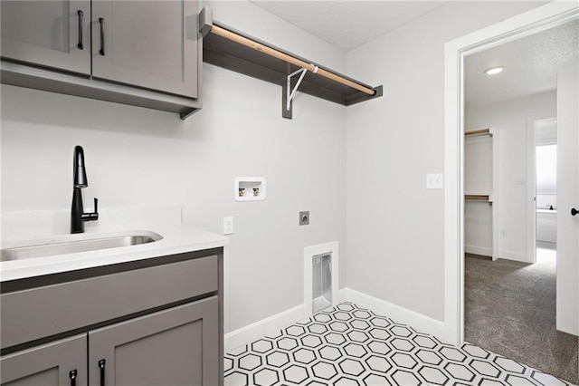 laundry room featuring light carpet, electric dryer hookup, sink, hookup for a washing machine, and cabinets