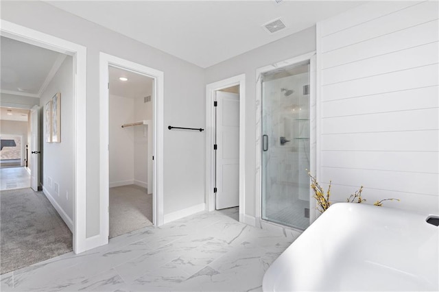 bathroom featuring ornamental molding and shower with separate bathtub