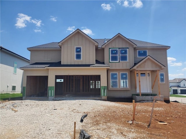 16875 Norton St, Olathe, KS 66062 - view of front of home with driveway, an attached garage, and board and batten siding