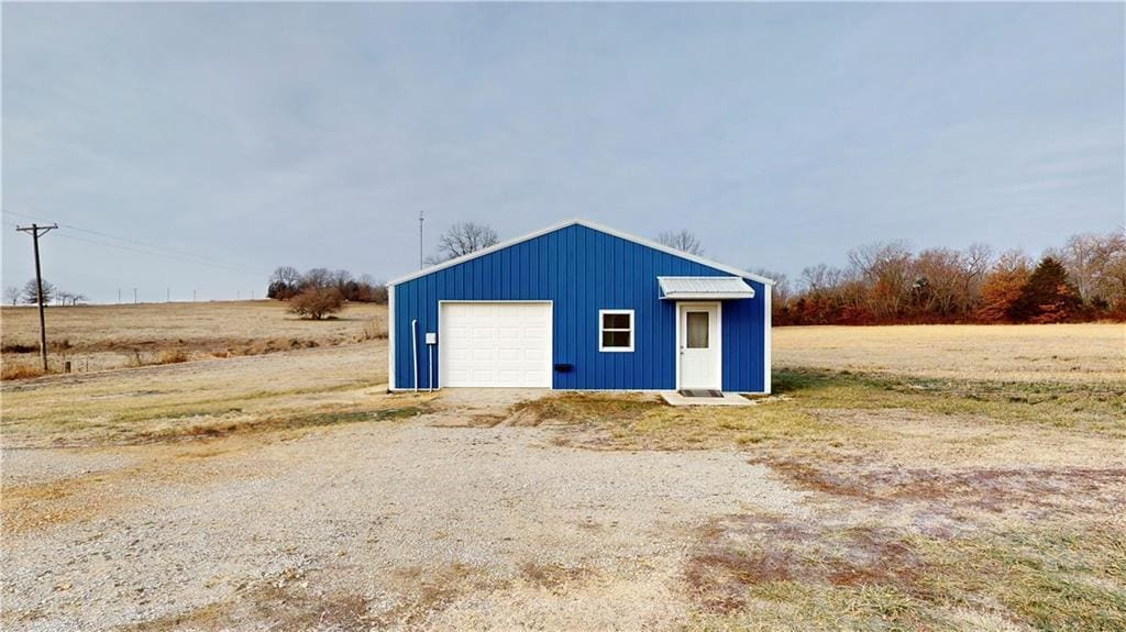 view of outbuilding featuring a garage and a rural view