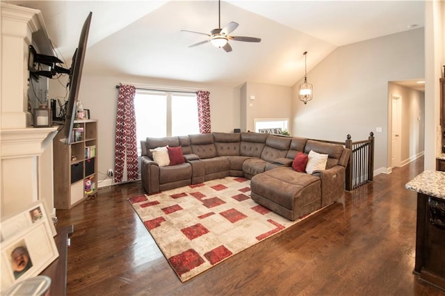 living room featuring lofted ceiling, dark hardwood / wood-style floors, and ceiling fan with notable chandelier