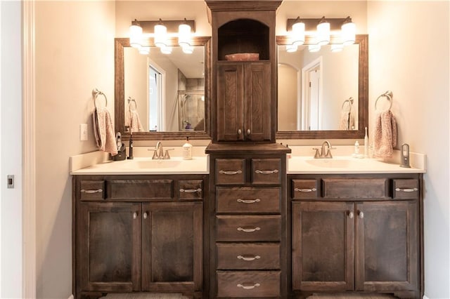 bathroom with vanity and a shower with door