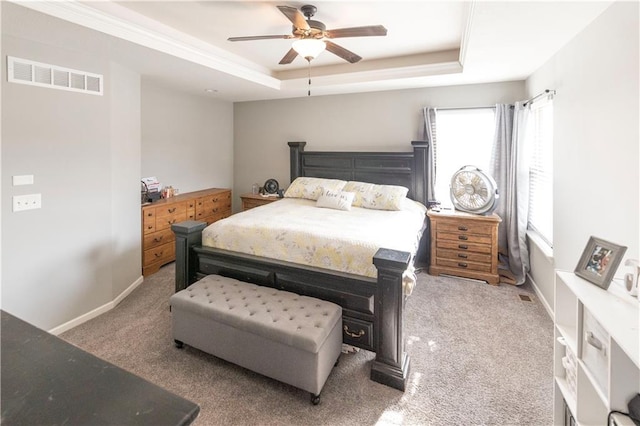 bedroom featuring ceiling fan, carpet, and a raised ceiling