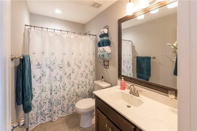 bathroom with toilet and vanity