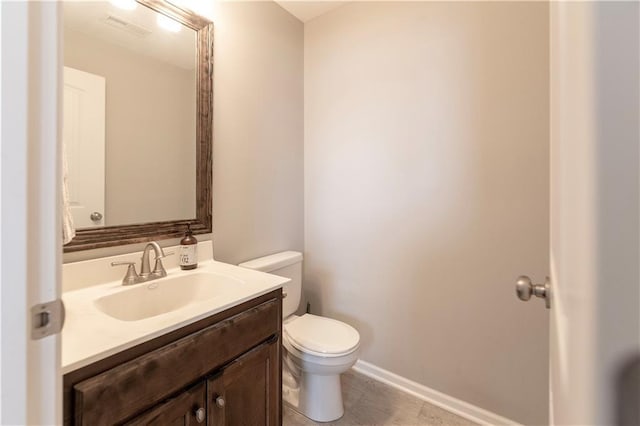 bathroom featuring toilet and vanity