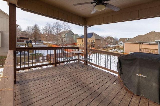 snow covered deck with ceiling fan and grilling area