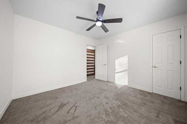 unfurnished bedroom featuring ceiling fan and carpet flooring