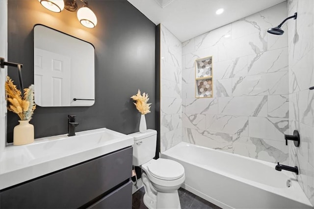 full bathroom featuring tiled shower / bath, vanity, and toilet