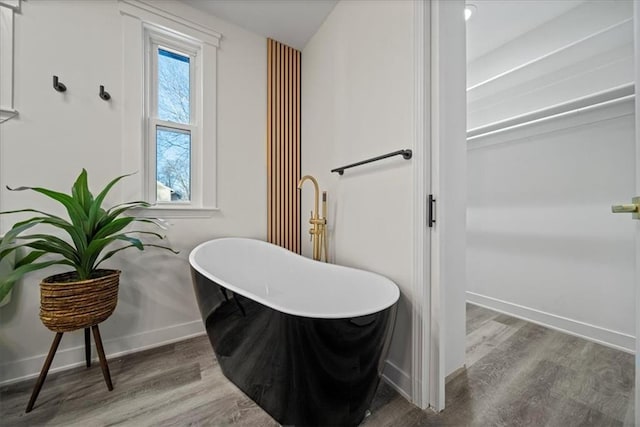 bathroom featuring hardwood / wood-style flooring and a bathing tub