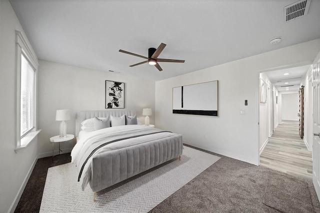 bedroom with ceiling fan and light colored carpet