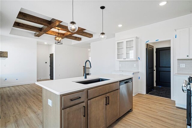 kitchen featuring white cabinets, dishwasher, an island with sink, sink, and coffered ceiling