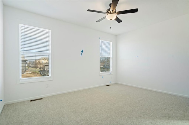 unfurnished room featuring light colored carpet and ceiling fan