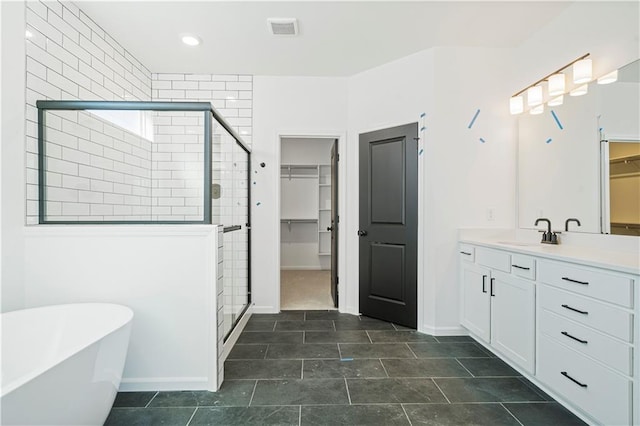 bathroom with vanity, tile patterned floors, and shower with separate bathtub