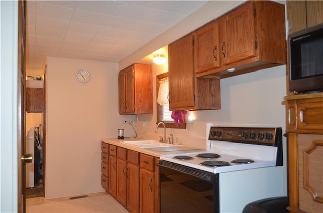 kitchen featuring white range with electric cooktop and sink