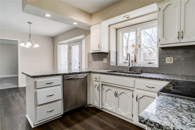 kitchen with a sink, a peninsula, white cabinets, and dishwasher