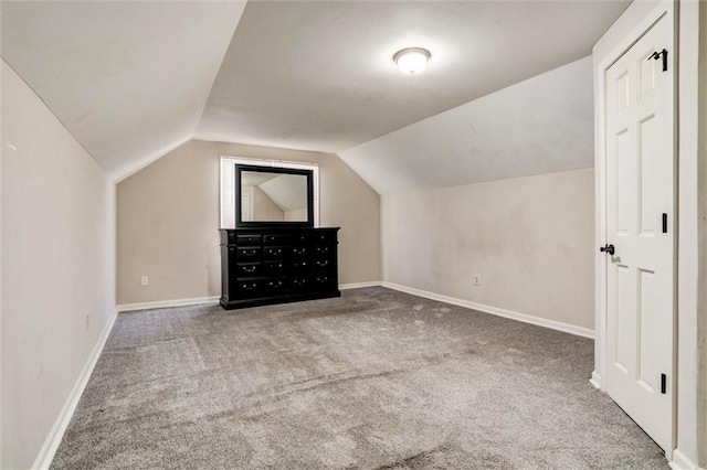 additional living space with lofted ceiling, carpet, and baseboards