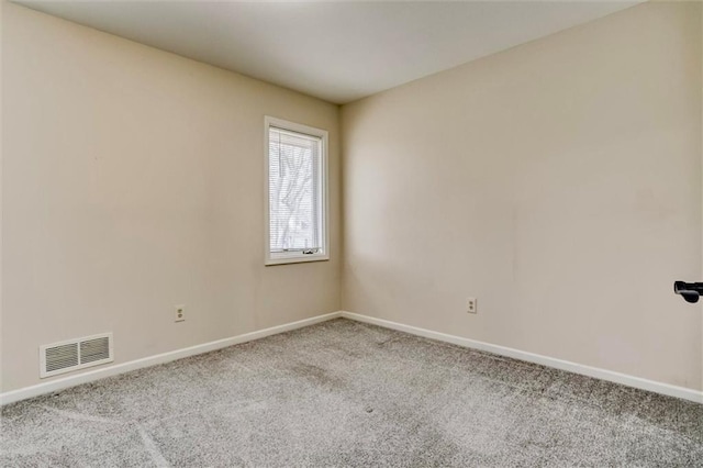 carpeted empty room with baseboards and visible vents