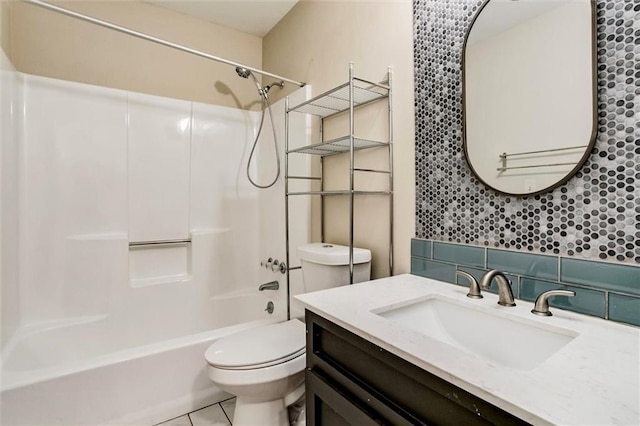 full bath with shower / washtub combination, backsplash, toilet, vanity, and tile patterned floors