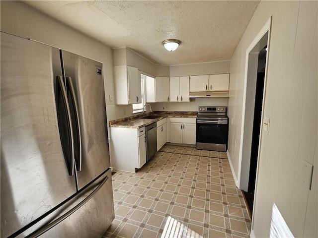 kitchen with white cabinets, sink, stainless steel appliances, and a textured ceiling