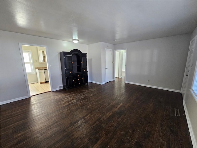 unfurnished living room with dark hardwood / wood-style flooring