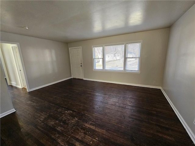 empty room featuring dark wood-type flooring