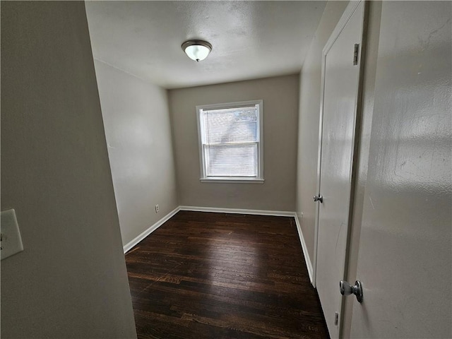 spare room with dark wood-type flooring