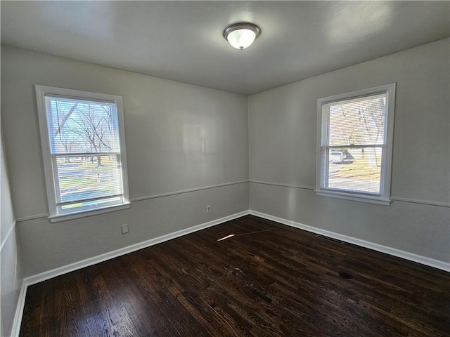 unfurnished room with dark wood-type flooring