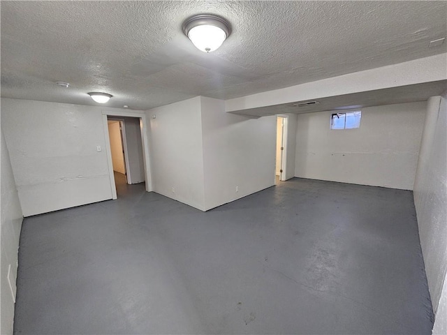 basement featuring a textured ceiling