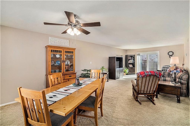 carpeted dining area featuring ceiling fan