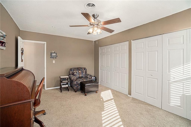 home office featuring ceiling fan and light carpet