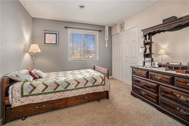 bedroom featuring a closet and light carpet