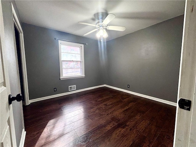 spare room featuring ceiling fan and dark hardwood / wood-style flooring