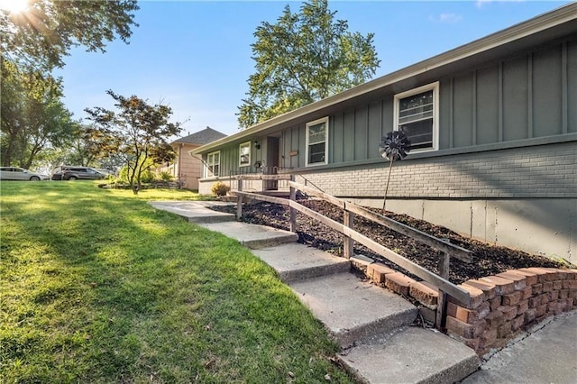 view of property exterior with a lawn